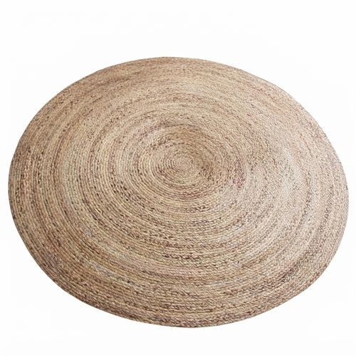 Round braided natural jute rug in a living room
