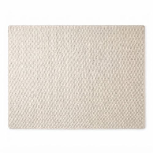 Ivory handwoven wool area rug in a dining room