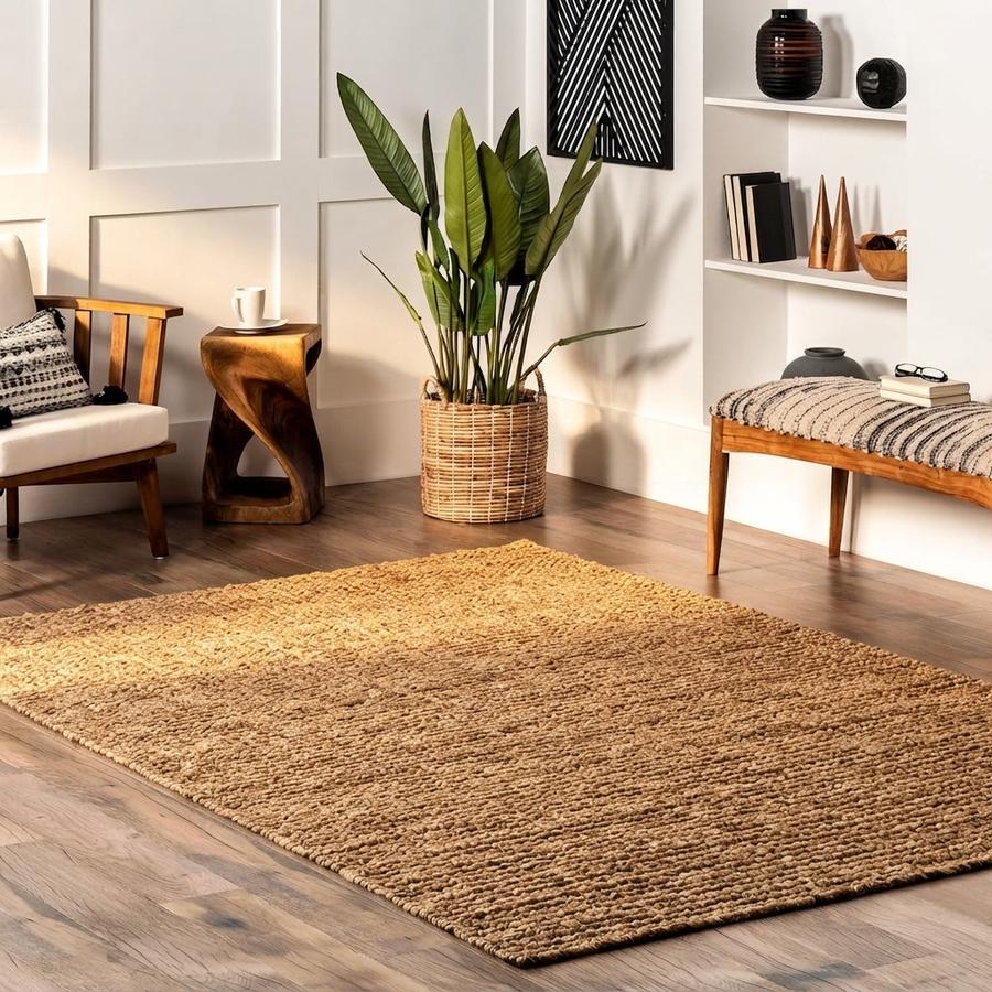 Grey handwoven cotton area rug beside a reading chair